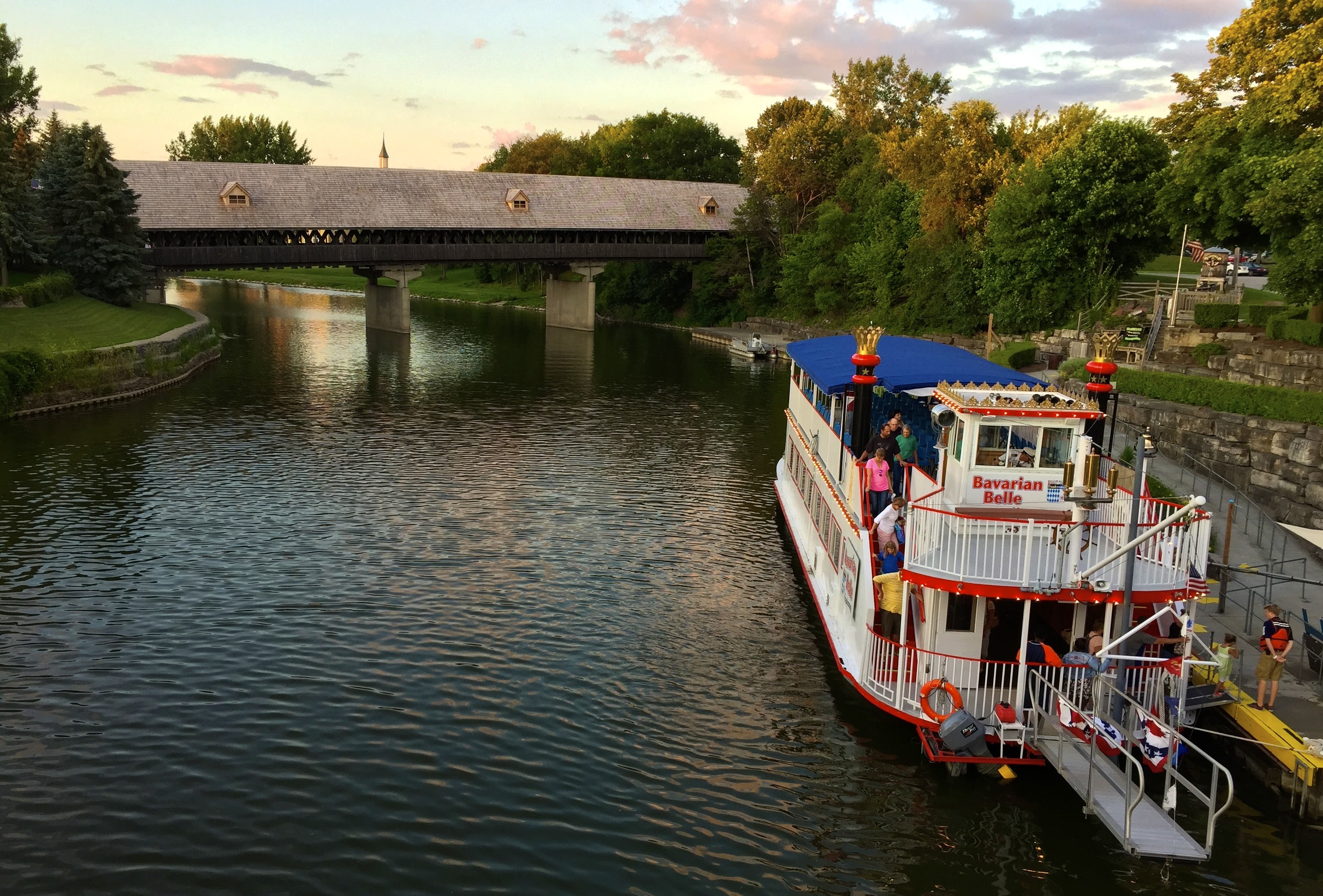 View of bridge from a second with bridge riverboat on the water